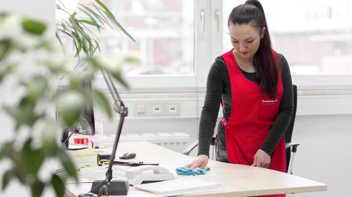 Woman cleans desk