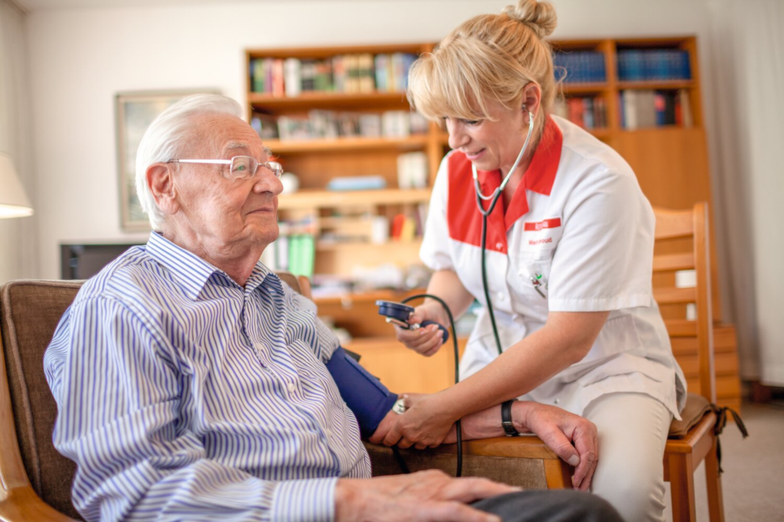 Nurse measures patient's blood pressure