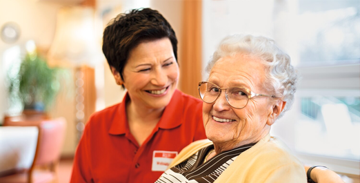 Caregiver chatting with senior