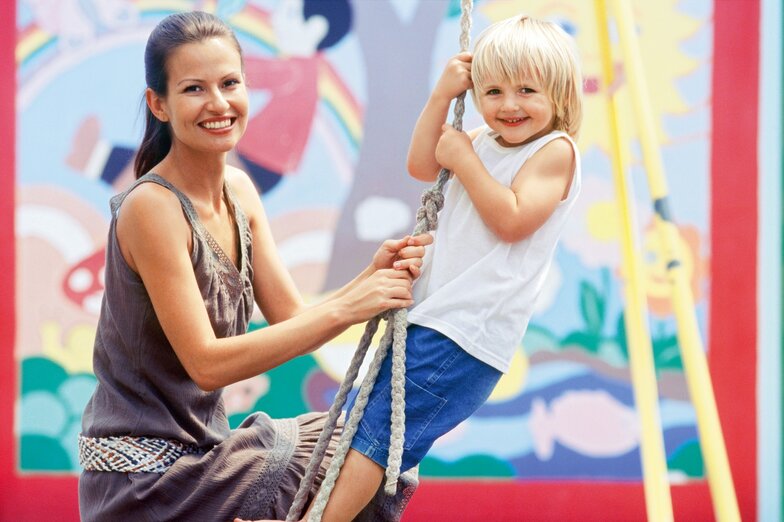 Educator swinging with child