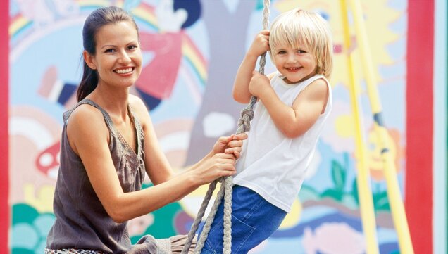 Educator swinging with child