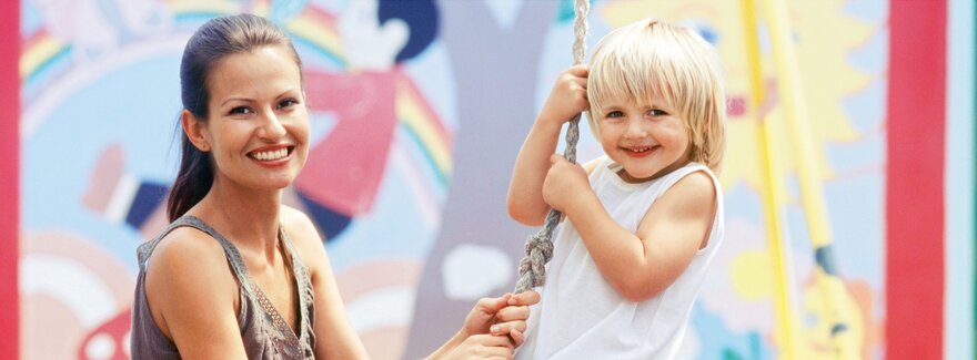 Educator swinging with child