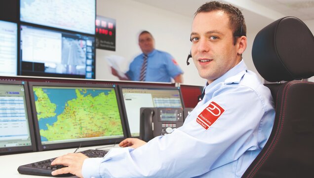 Security guard sits in alarm receiving station