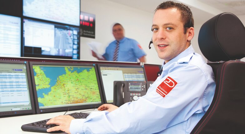 Security guard sits in alarm receiving station