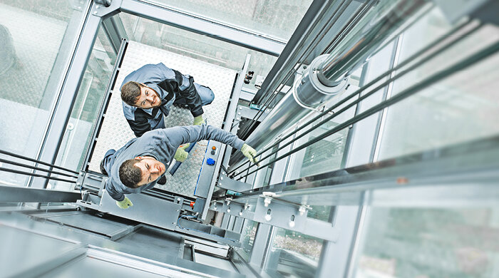 Elevator technician in glass elevator