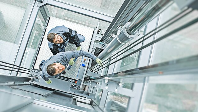 Elevator technician in glass elevator