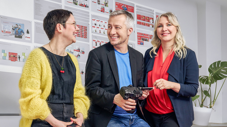 Group in front of a wall with communication and marketing materials