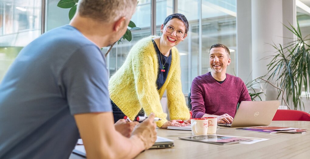 Creative meeting with laptop and marketing materials