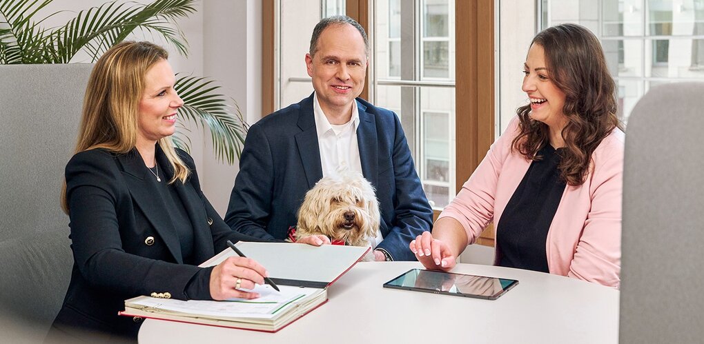 Discussion round with laptop and documents in bright office