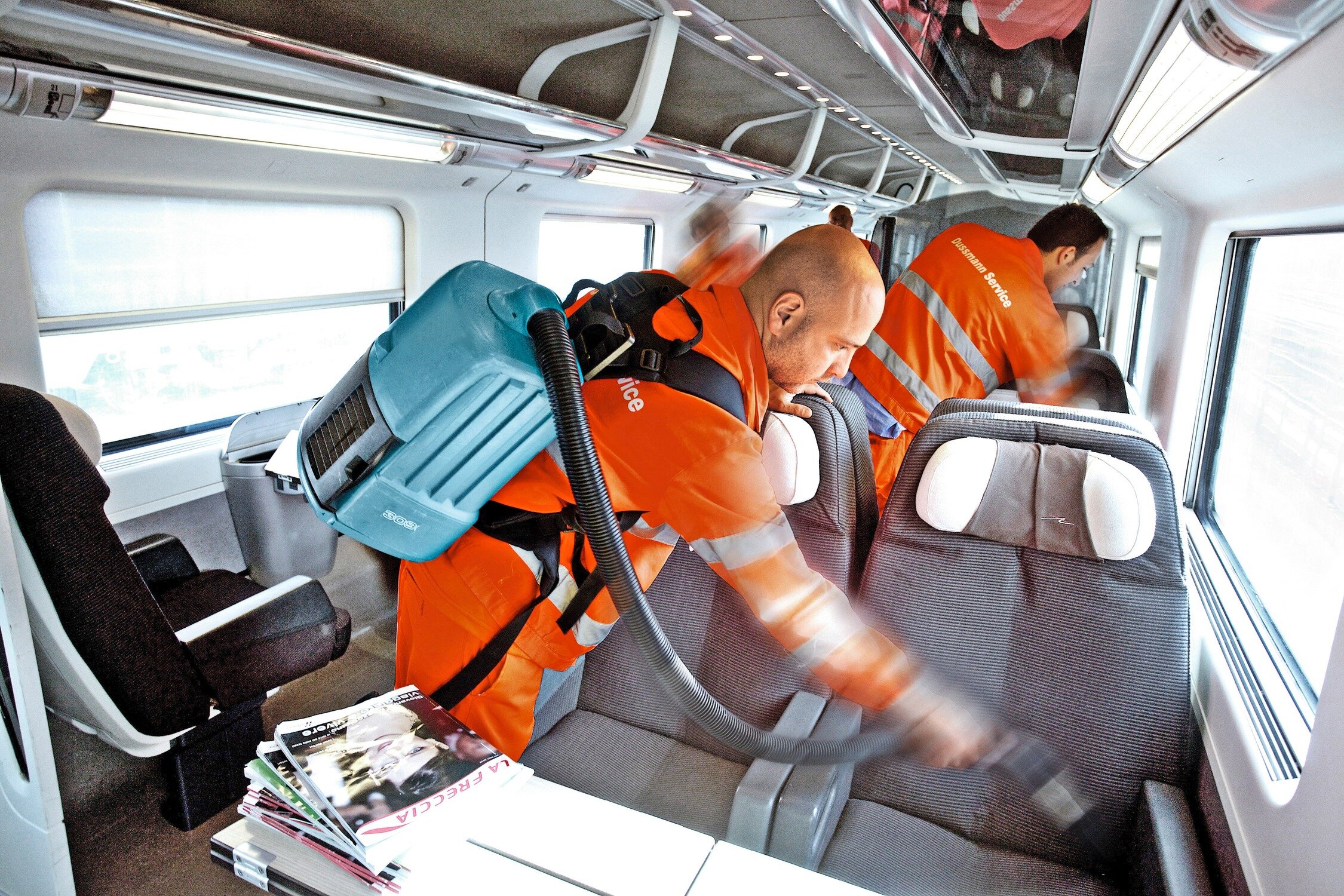 Cleaning staff clean seats in a train